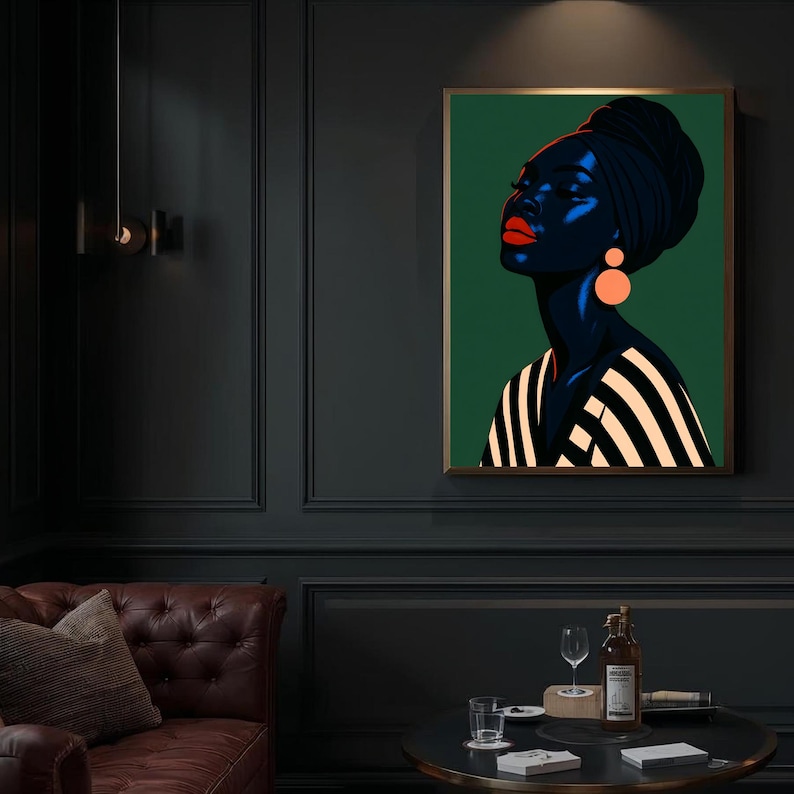 May include: A framed art print featuring a stylized portrait of a woman with dark skin, wearing a black head wrap and orange earrings. The woman's lips are red, and she is wearing a black and white striped top. The background is a solid green.