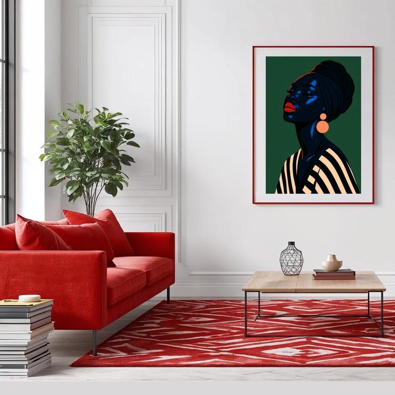 May include: A framed art print featuring a stylized portrait of a person with dark skin, wearing a head wrap and orange earrings. The person is wearing a black and white striped top. The background is a deep green.