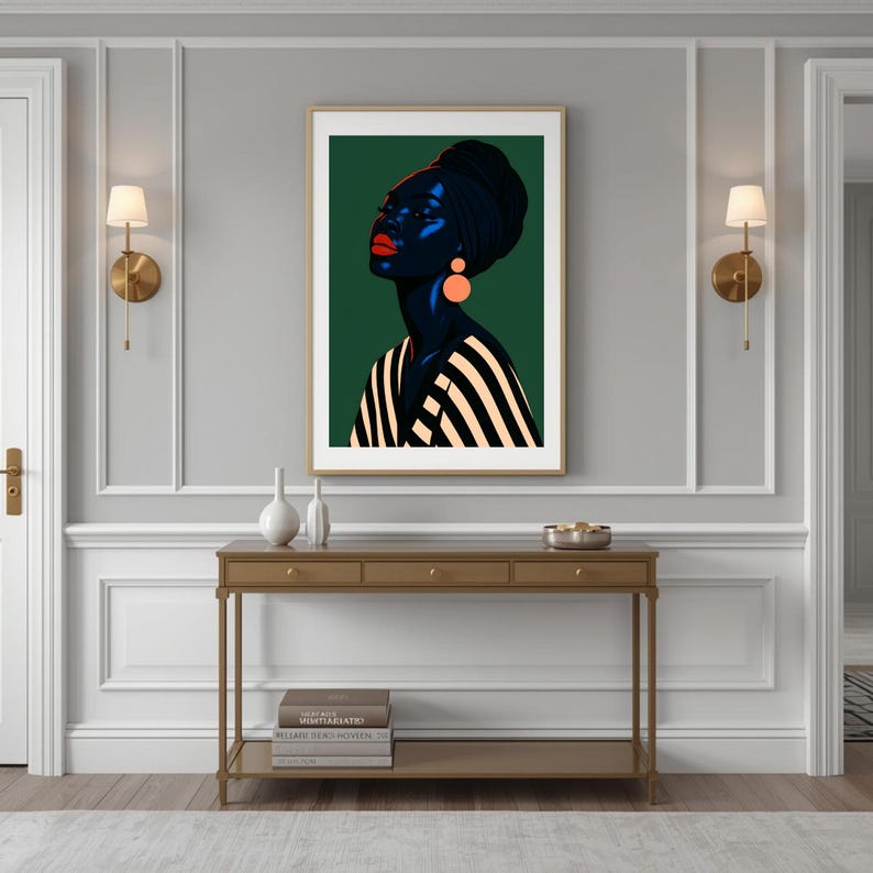 May include: A framed art print featuring a stylized portrait of a person with dark skin, wearing a black head wrap and striped top. The person has red lips and orange earrings, set against a dark green background.