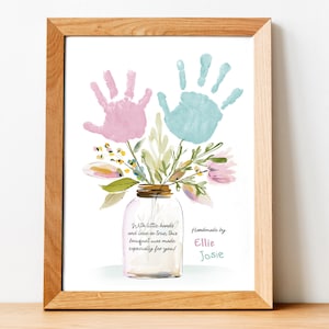 May include: Framed print with a watercolour illustration of a floral bouquet in a jar, topped with pink and blue handprints. The text says "With little hands and love so true, this bouquet was made especially for you!" and "Handmade by Ellie Josie."