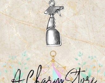 May include: A silver-colored charm in the shape of a spray bottle, featuring a trigger and a rounded base. The charm is suspended against a marble-patterned background. The text "A Charm Store" is written in cursive.