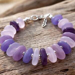 Made with a diamond glass drill bit and your Dremel tool.  a purple and white drill sea glass bracelet.