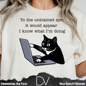 May include: Cream-colored t-shirt featuring a black cat cartoon interacting with a laptop. The text above the cat reads, "To the untrained eye, it would appear I know what I'm doing."