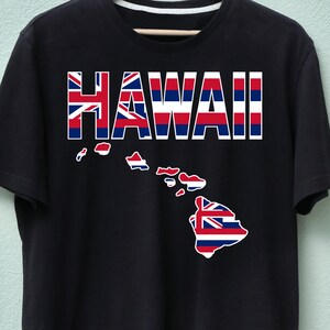 May include: Black t-shirt featuring the word "HAWAII" in a bold, block letter design. The letters are filled with a pattern of the Hawaiian flag and the outline of the Hawaiian islands.
