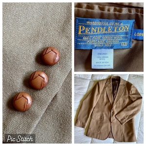 May include: A tan Pendleton blazer with three brown leather buttons. The blazer is made of 100% virgin wool and has a label that reads "Pendleton" and "Made in USA". The blazer is a classic style.