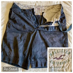 May include: Dark blue shorts with a button closure and a faded pattern. The shorts have a label that reads "Hollister California". The shorts are size 36 and made of 70% cotton.