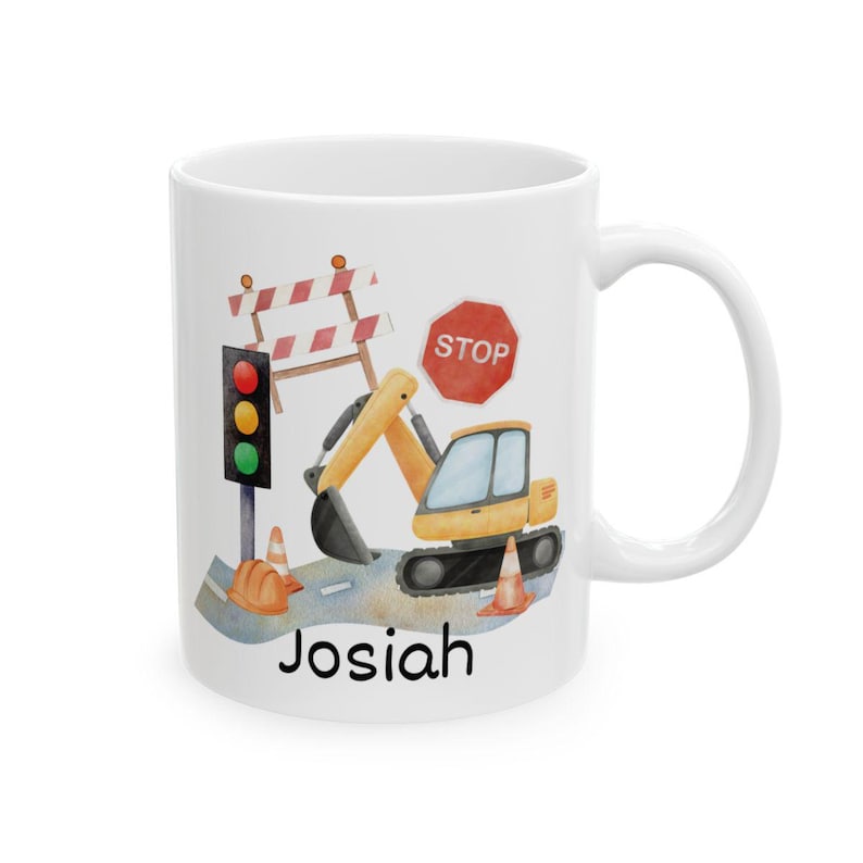 May include: White ceramic mug featuring a watercolor illustration of a yellow excavator, stop sign, traffic light, and road construction elements. The name "Josiah" is printed at the bottom. A fun gift for construction enthusiasts.