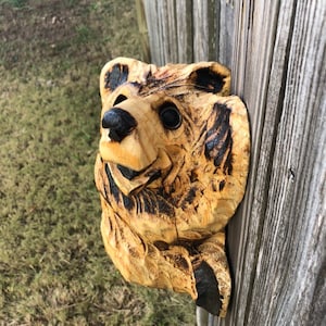 Chainsaw Carving Climbing Bear Hangs on a Post Looking to the Right