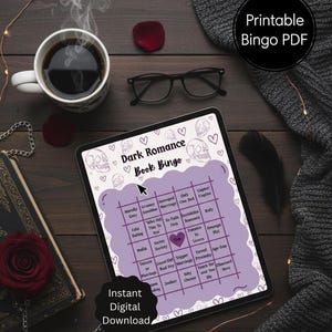 May include: A digital tablet shows a "Dark Romance Book Bingo" game with skull and heart illustrations. The image includes a coffee cup, glasses, a rose, and the text "Instant Digital Download."