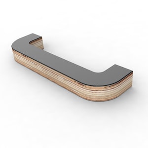May include: A curved wooden counter with a grey top. The counter is made of plywood with visible layers of wood.
