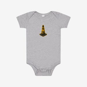 May include: A heather gray short-sleeve bodysuit featuring a centered graphic of a yellow and black traffic cone with the text HOIST THE CONE printed on the side. The garment has a round neckline and a snap closure at the bottom for easy access.