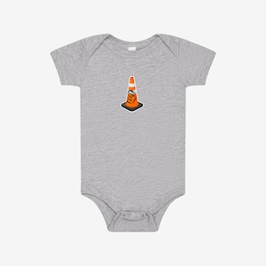 May include: A heather gray short-sleeve baby bodysuit featuring a centered graphic of an orange traffic cone with a black base. The cone has a white horizontal stripe and black text that reads HOIST THE CONE printed on its side.