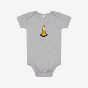 May include: A heather gray short-sleeve baby bodysuit featuring a centered graphic of an orange and yellow traffic cone with a black base. The cone has a small white sign attached to its side with the black text "HOIST THE CONE" printed on it.