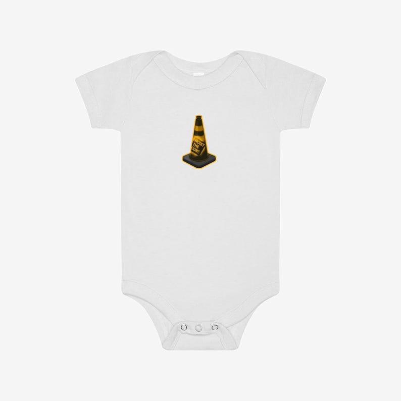 May include: A white short-sleeved baby bodysuit featuring a centered graphic of a yellow and black traffic cone. The cone has the text HOIST THE CORE printed in black letters on its side. The garment has a round neckline and snap closures.