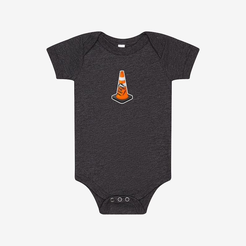 May include: A dark charcoal grey short-sleeve baby bodysuit featuring a centered graphic of an orange traffic cone with a white stripe. The cone includes a small rectangular sign with the black text HOIST THE CONE printed on its front surface.