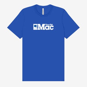 May include: A royal blue t-shirt featuring the text "This Old Mac" in white. The design includes a white graphic of an old computer. The shirt is a classic crew neck style.