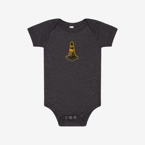 May include: A dark charcoal grey short-sleeve baby bodysuit featuring a centered graphic of a yellow and black traffic cone. The cone includes the text "HOIST THE CORE" printed in black lettering on its side, with a square base and short sleeves.