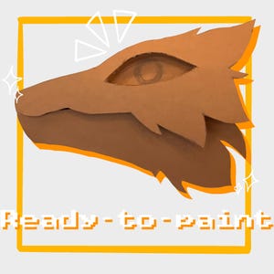 May include: A brown, stylized animal head mask base with a pointed snout and ear shape, framed by an orange square border. The text Ready-to-paint is displayed in white pixelated font at the bottom, accompanied by white star and triangle icons.