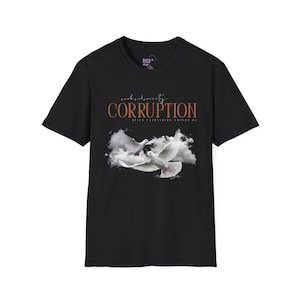 May include: A black short-sleeve t-shirt featuring a graphic of two white doves flying amidst clouds. The text CORRUPTION is printed in orange above the birds, with smaller script text above and below the word, and the brand logo inside the neck.