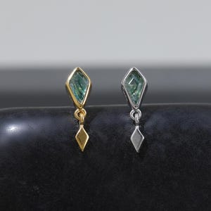 May include: Two small dangle earrings, one in gold tone and one in silver tone, each featuring a kite-shaped green gemstone set in a metal frame with a matching kite-shaped metal charm hanging from a small jump ring below the stone setting.