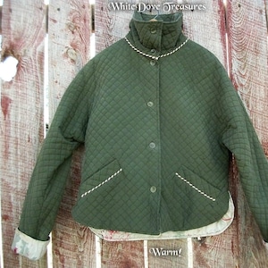 May include: A green quilted jacket with a white trim around the collar and pockets. The jacket has a button closure and a warm lining.