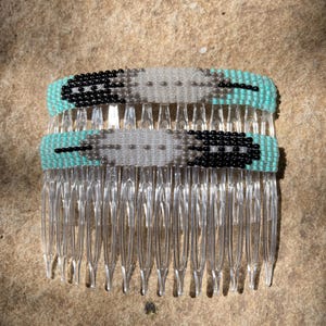 May include: Two beaded hair combs with a turquoise, white, and black feather design.