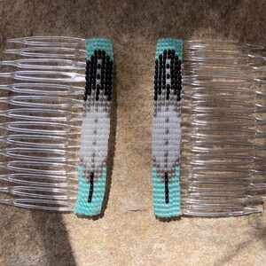 May include: Two turquoise and white beaded hair combs with a feather design. The combs are made of clear plastic.