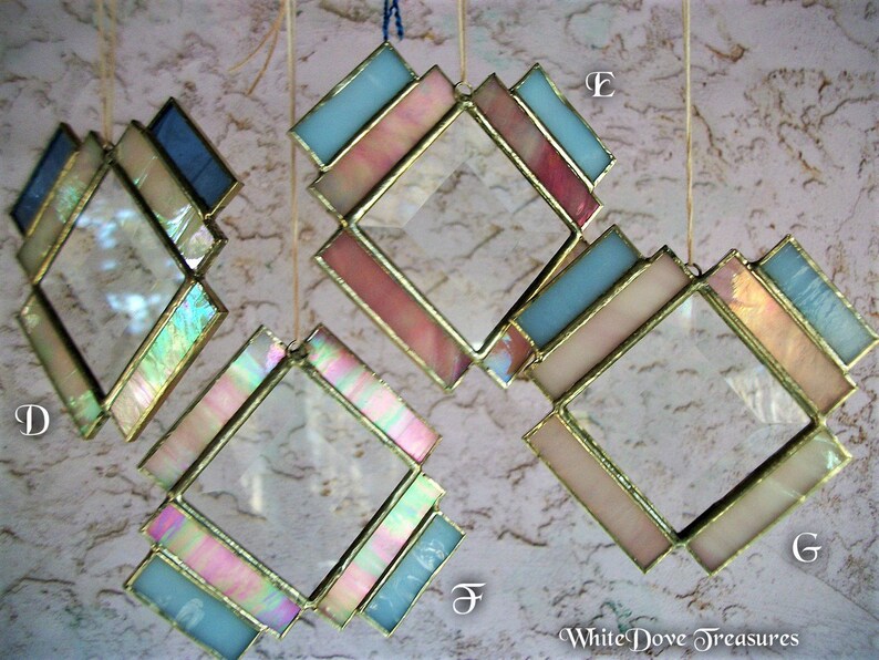May include: Four diamond-shaped stained glass suncatchers with iridescent glass and gold trim. The suncatchers are hanging from strings and are labeled with the letters D, E, F, and G.