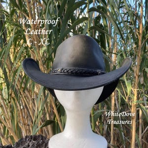 May include: A black leather cowboy hat with a braided band and a white stitching detail. The hat is labeled "Waterproof Leather L-XL" and "WhiteDove Treasures".