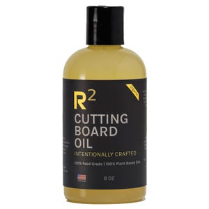 May include: A yellow bottle of R2 Cutting Board Oil with a black label. The label includes the text "INTENTIONALLY CRAFTED" and "100% Food Grade | 100% Plant Based Oils". The bottle contains 8 oz of oil and is labeled "Organic".