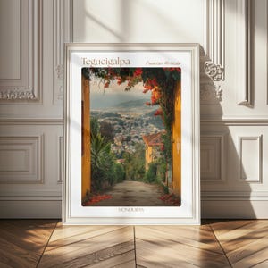 May include: A framed wall art print featuring a scenic view of Tegucigalpa, Francisco Morazán, Honduras. The image shows a path framed by yellow walls and vibrant red bougainvillea flowers, leading to a distant cityscape under a soft sky.