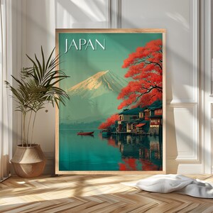 May include: Framed art print featuring a Japanese landscape with Mount Fuji in the background. The artwork depicts a lake with a small boat, traditional buildings, and vibrant red trees. The word "JAPAN" is displayed at the top.