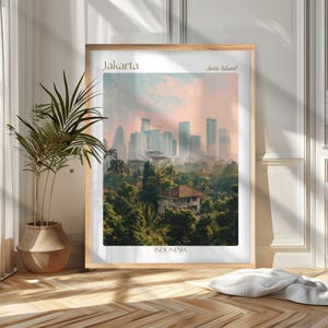 May include: A framed print featuring a cityscape of Jakarta, Indonesia, with a hazy, pastel-colored sky. The image showcases modern skyscrapers rising above lush green trees and buildings. Text includes "Jakarta", "Java Island", and "Indonesia".