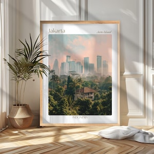 May include: A framed print featuring a cityscape of Jakarta, Indonesia, with the text "Jakarta" and "Java Island." The image showcases a skyline with tall buildings, lush green trees, and a soft, pastel-colored sky.