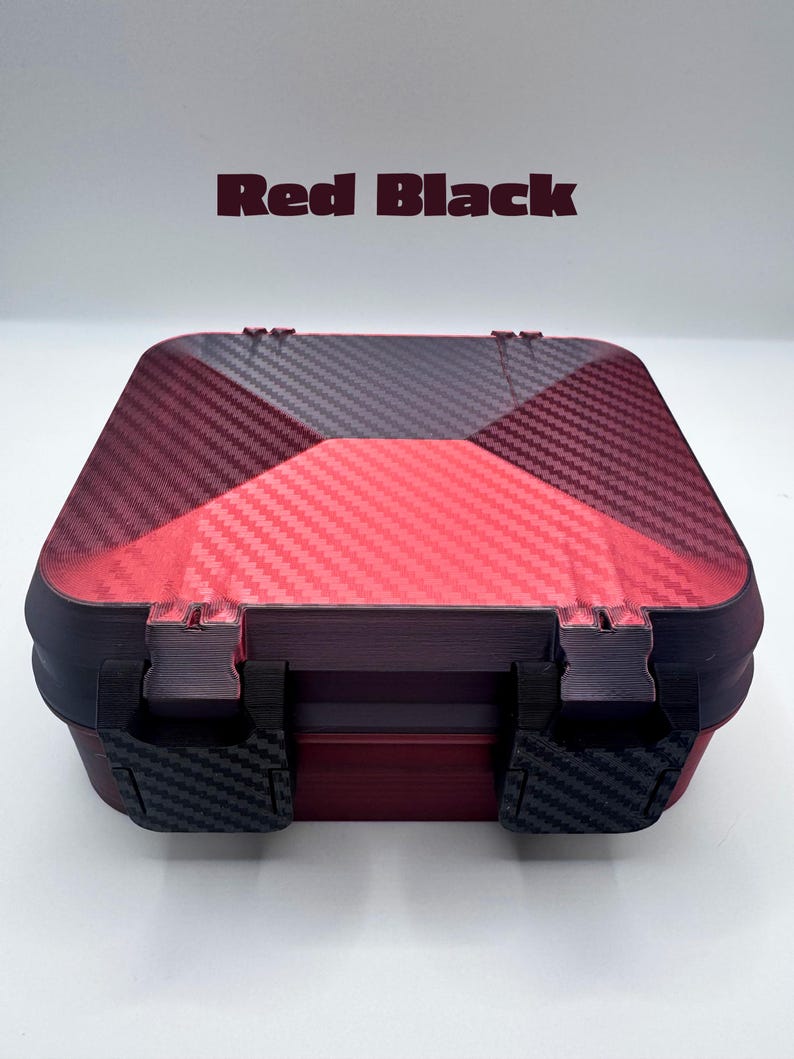 May include: A square storage box with a red and black carbon fiber pattern on the lid. The box features two black latches on the front and the text Red Black is printed in dark red above the container against a plain white background.
