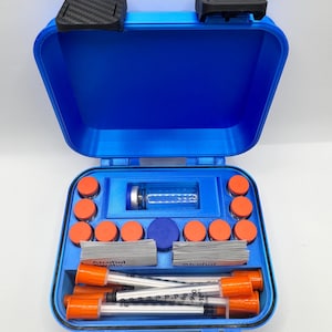 May include: A bright blue, rectangular, hard-shell carrying case with black latches. The interior features custom-molded compartments holding a clear glass vial, ten small orange-capped containers, two stacks of alcohol swabs, and four syringes.