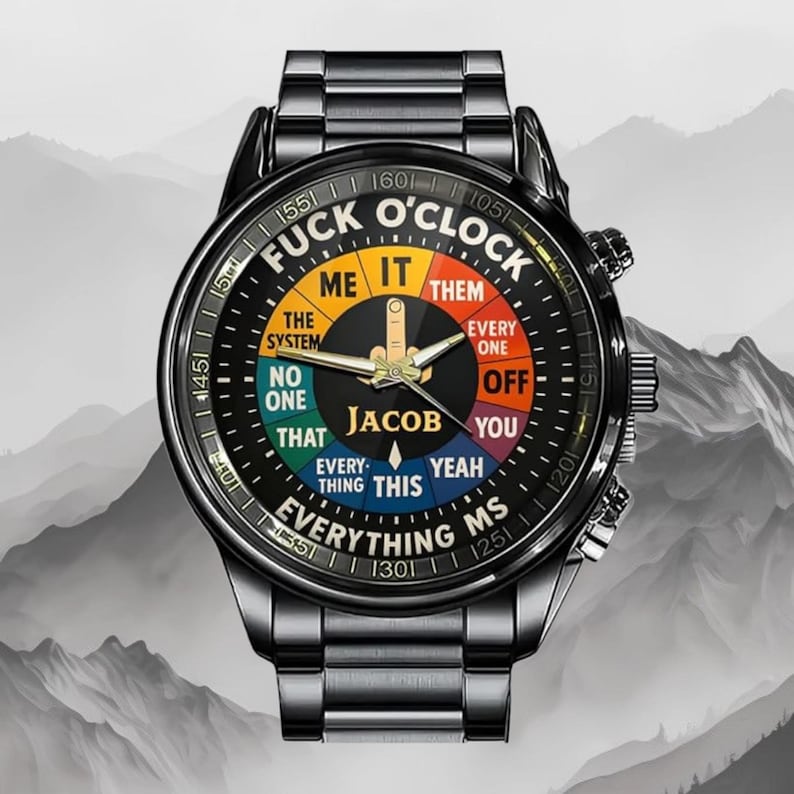 May include: Black wristwatch with a round face featuring the text "FUCK O'CLOCK" and various phrases. The watch has a black metal band and a black face with colorful segments. The name "JACOB" is also on the watch face.