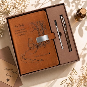 May include: A brown leather journal and pen set in a gift box. The journal features a Winnie the Pooh design and the text "Mrs. Emily, Never Forget The Difference You Make, Thank you, Lucia". A card that says "Best Teacher Ever!" is also included.