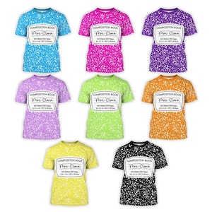 May include: Nine colorful t-shirts with a composition book design. Each shirt features a unique color, including blue, pink, purple, green, orange, yellow, and black. The shirts have a white label with text.