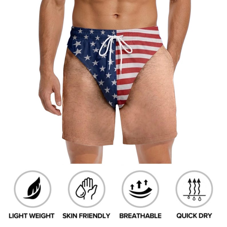 May include: Swim trunks featuring a split design with a blue field of white stars on the left and red and white horizontal stripes on the right. The shorts include a white drawstring at the elastic waistband and a realistic skin-tone print.