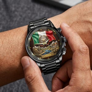 May include: Black wristwatch with a detailed face featuring the Italian flag, a star, and landmarks. The watch has a black metal band and a textured dial. The name "JACOB" is printed on the watch face.