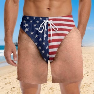 May include: Swim trunks featuring a split design with a blue field of white stars on the left side and horizontal red and white stripes on the right side. The garment includes a white drawstring at the elastic waistband for a secure fit.
