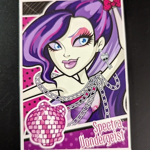 May include: A purple-haired monster girl with a pink disco ball and the text "Spectra Wondergeist" on a pink and purple background.