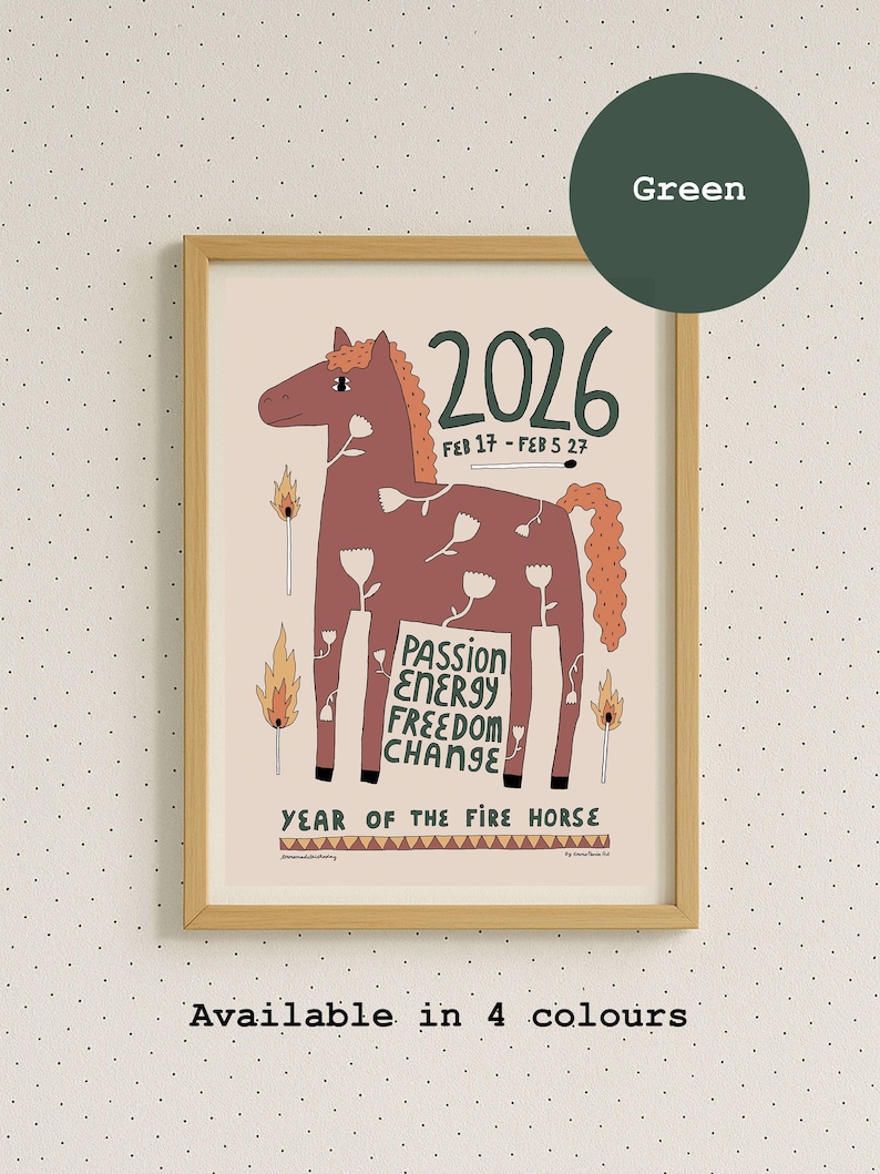 A framed wall art print featuring a brown horse illustration with white flower outlines, lit matches, and flames. Text includes 2026, FEB 17 - FEB 5 27, PASSION ENERGY FREEDOM CHANGE, and YEAR OF THE FIRE HORSE. The frame is light-colored wood. Available with green text.