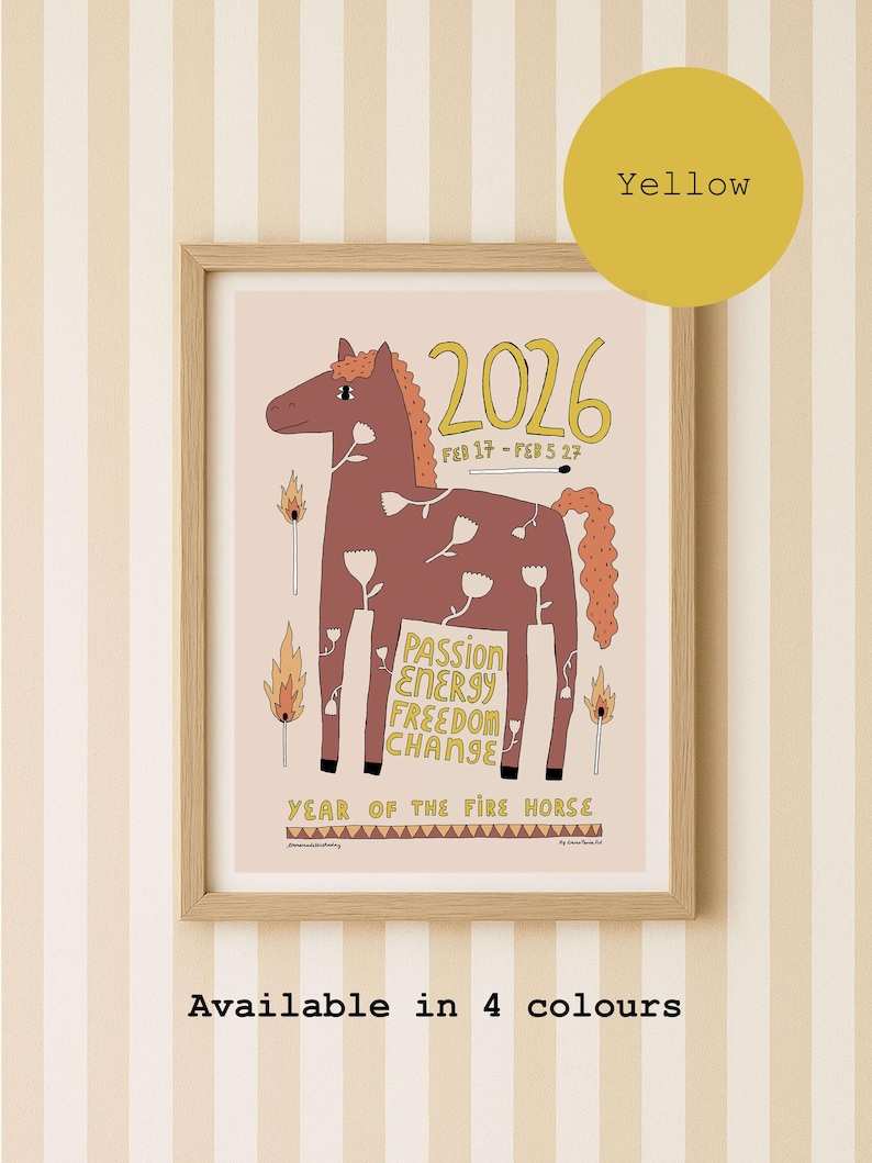 A framed art print featuring a brown horse illustration with white flower patterns, the text 2026, FEB 17 - FEB 5 27, PASSION ENERGY FREEDOM CHANGE, and YEAR OF THE FIRE HORSE. The design includes matchstick graphics and is available with yellow text colour.