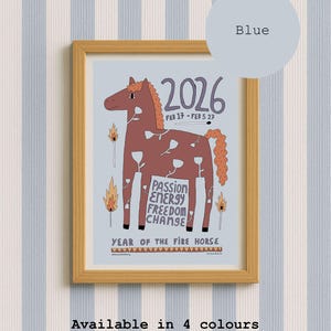 A framed print featuring a brown horse illustration with white flower outlines, the text 2026, FEB 17 - FEB 5 27, PASSION ENERGY FREEDOM CHANGE, and YEAR OF THE FIRE HORSE. The design includes lit matchsticks on a light blue background.