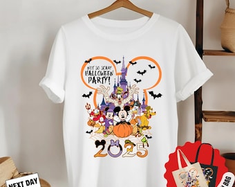 May include: White t-shirt featuring a colorful Halloween design with Mickey Mouse and friends. The design includes a castle, bats, and the text "NOT SO SCARY HALLOWEEN PARTY!" and "2025". A free 15x15 inch cloth bag is also included.