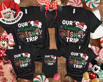 May include: Black family matching t-shirts with the text "OUR Family DISNEY TRIP" in red, green, and white. The shirts have personalized names under a Santa hat. A Minnie Mouse headband and a tote bag are also visible.