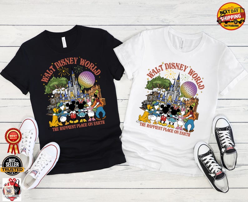 May include: Black and white t-shirts with a colorful graphic featuring Disney characters, a castle, and the text "WALT DISNEY WORLD" and "THE HAPPIEST PLACE ON EARTH." White and black sneakers are placed near the shirts.