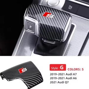 May include: Carbon fiber gear shift cover with a red and white "S" logo. The cover is designed for Audi A7, A6, and Q7 models from 2019-2021. The style is "G" and the color is "S".